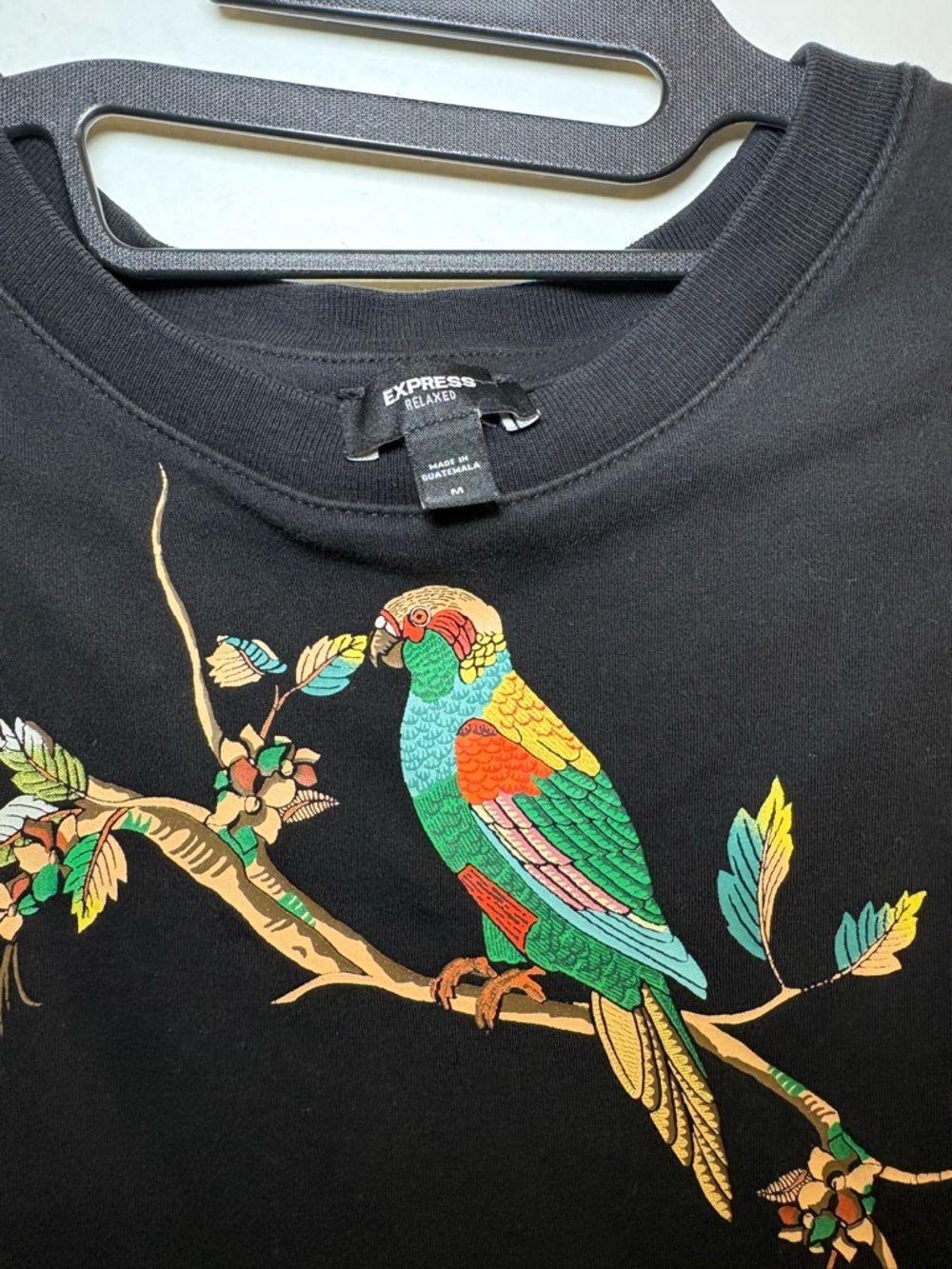 Express Black Tee with Colorful Parrot Illustration